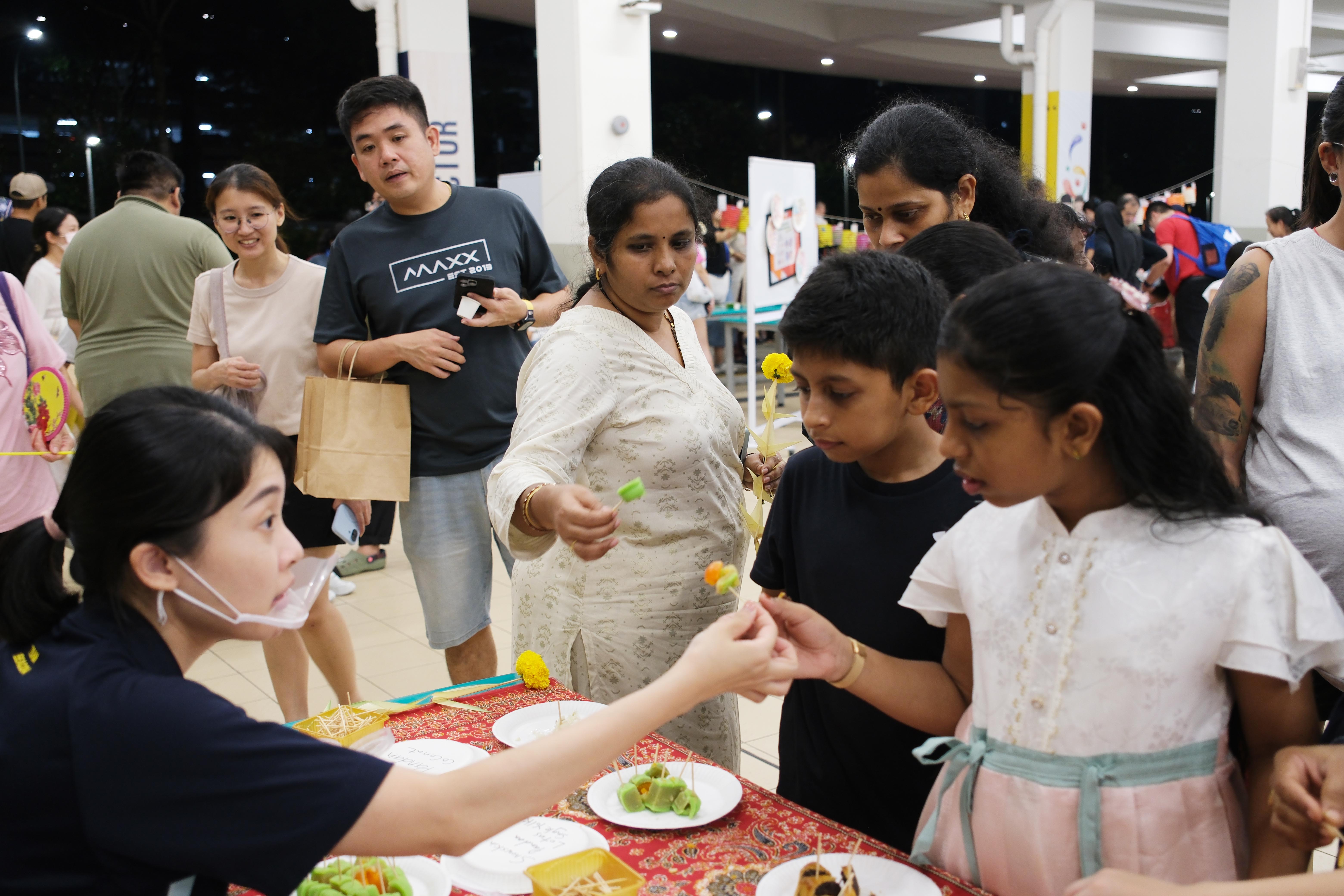 A taste of culture! Families and students tasting different mooncakes flavours together.
